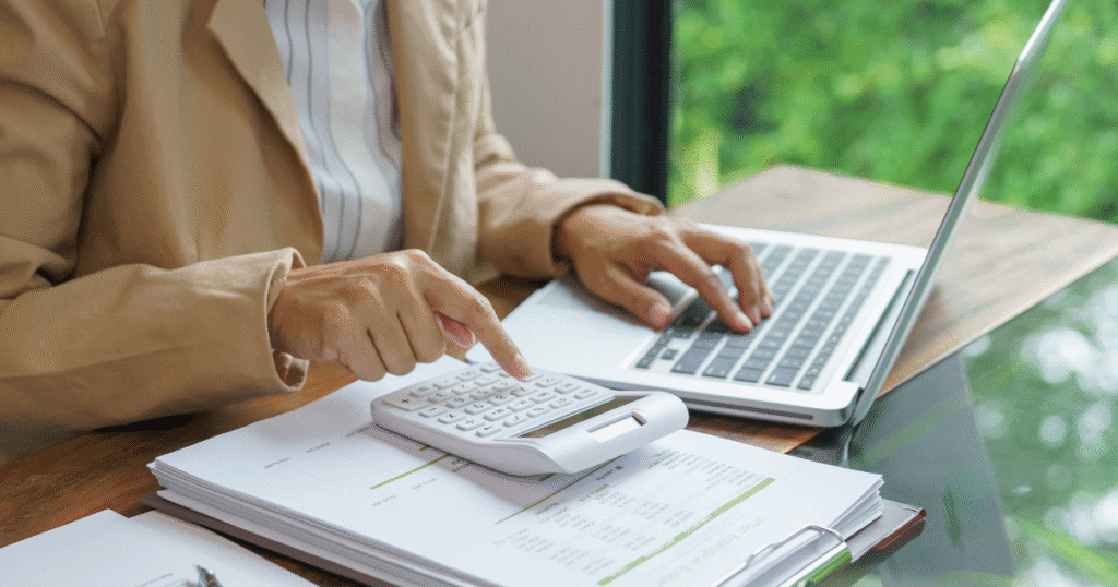 A young woman analyzing financial data and calculating investment returns, representing strategic planning for alternative investments and year-end decisions.