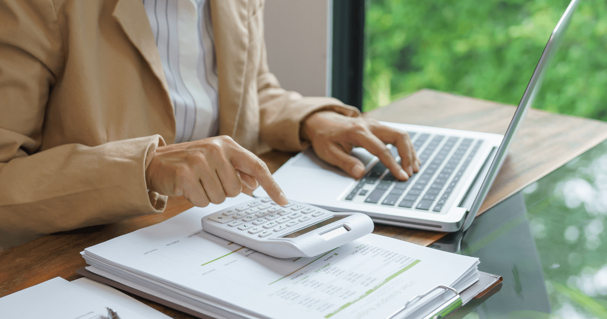 A young woman analyzing financial data and calculating investment returns, representing strategic planning for alternative investments and year-end decisions.