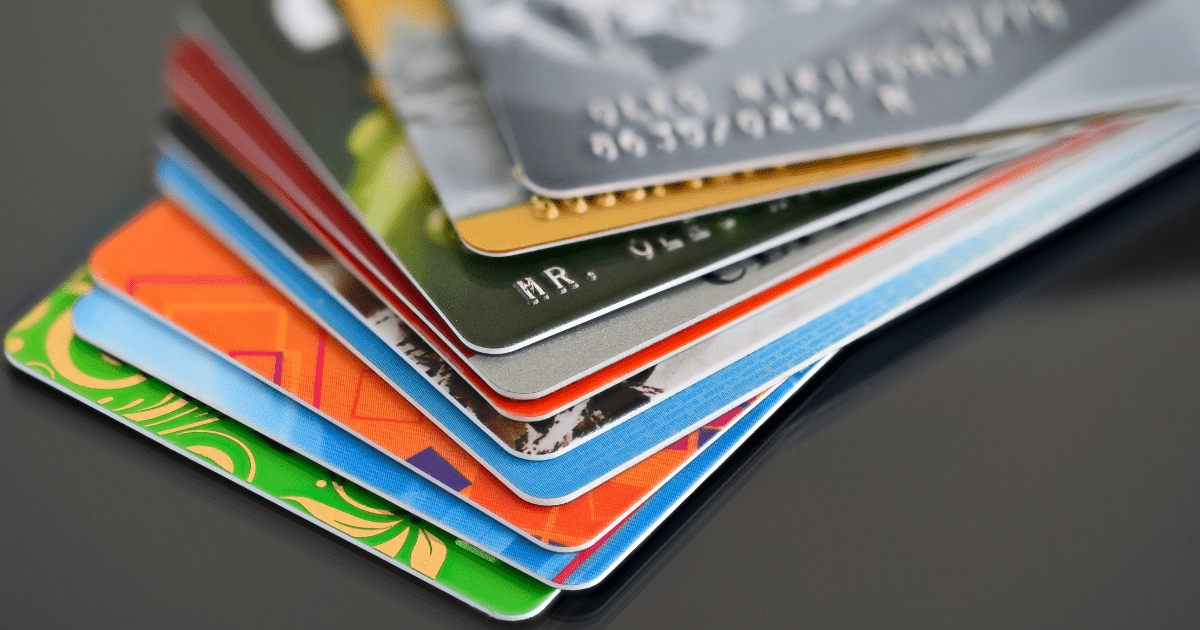 Multiple credit cards stacked together illustrating credit utilization and debt management strategies